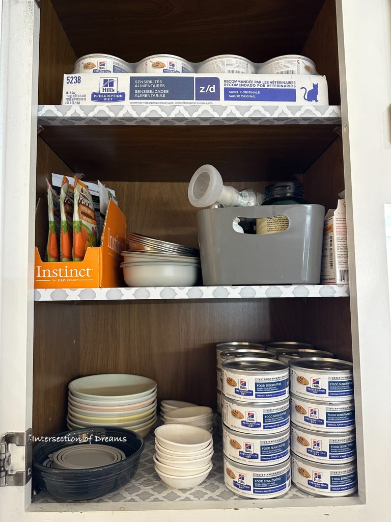 Cabinet full of kitty food and supplies